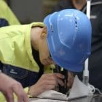 worker inspecting surface cleanliness with a magnifier