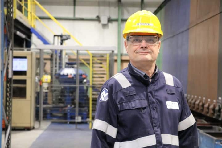 Christophe Bertoncelli in uniform standing in technical center